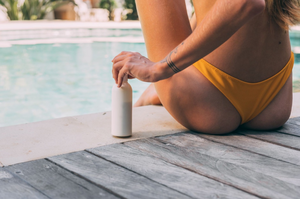 Spanish person with water bottle and sunscreen in hot weather
